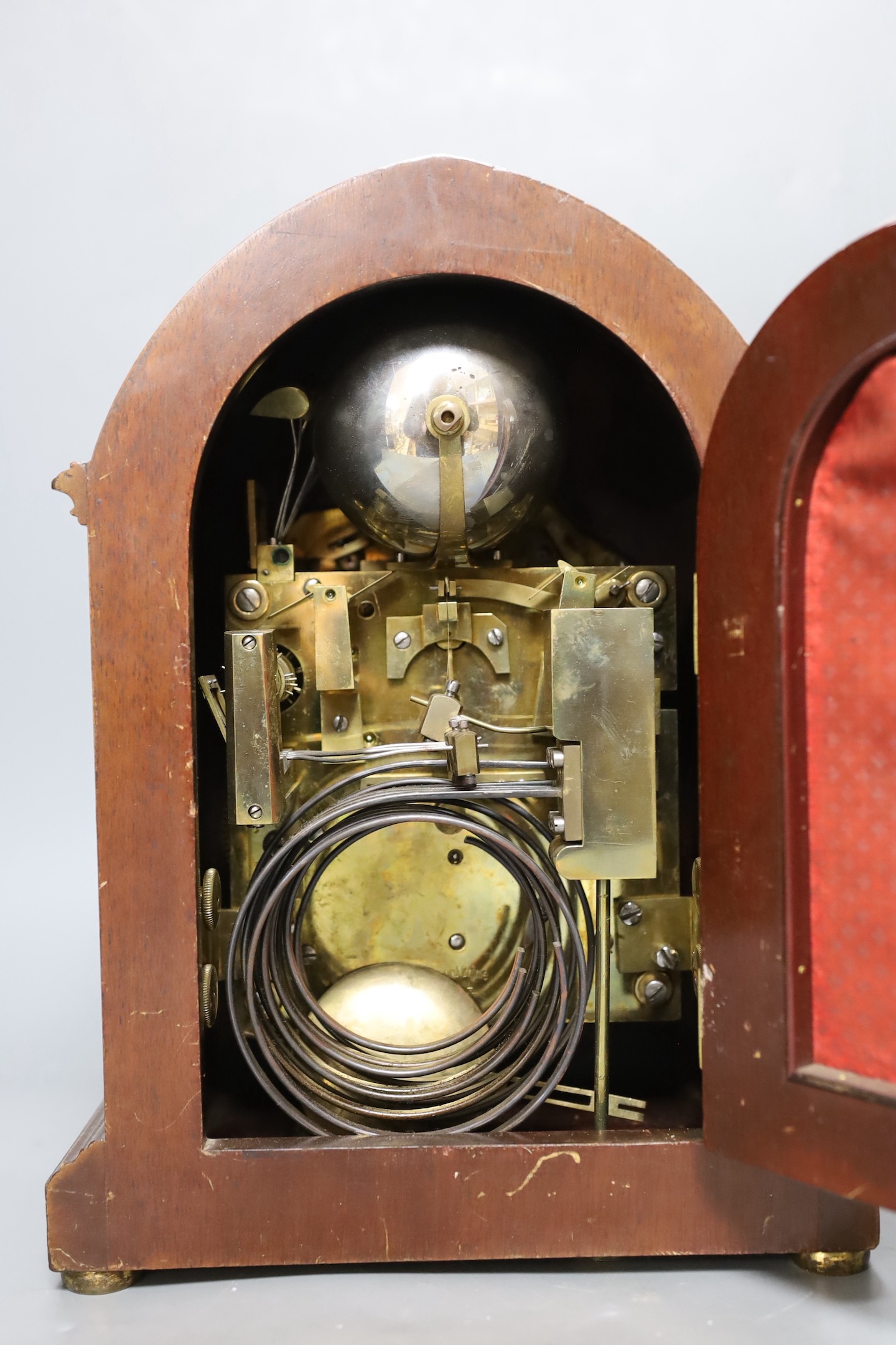A George V inlaid walnut lancet shaped chiming mantel clock, with German movement and 15th July 1914 presentation plaque. 29cm high